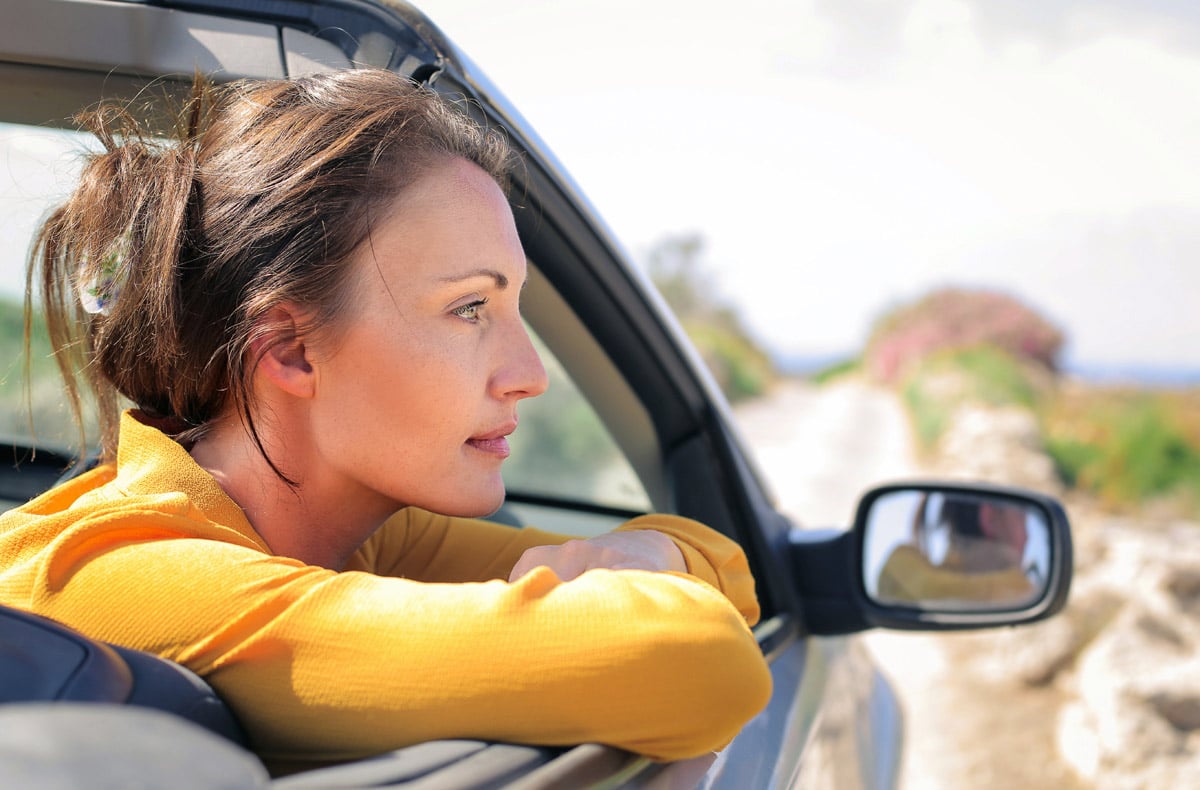 Car passenger looking out of the car window