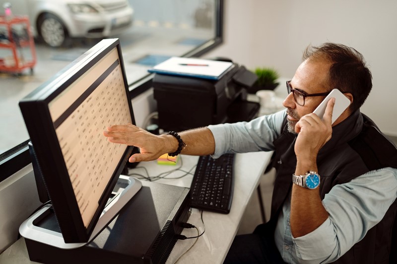 Fleet manager at work in front of computer
