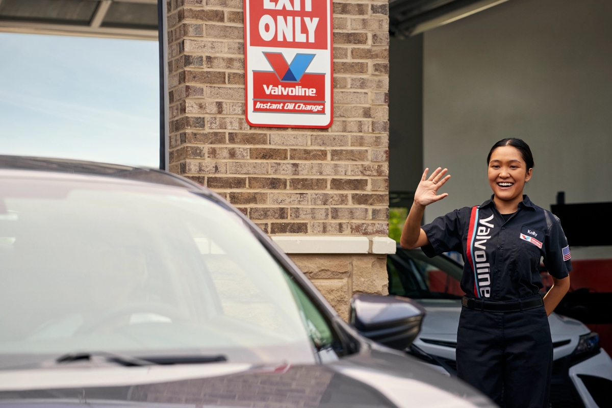 Valvoline CSR waves bye to a customer after an oil change service at Valvoline
