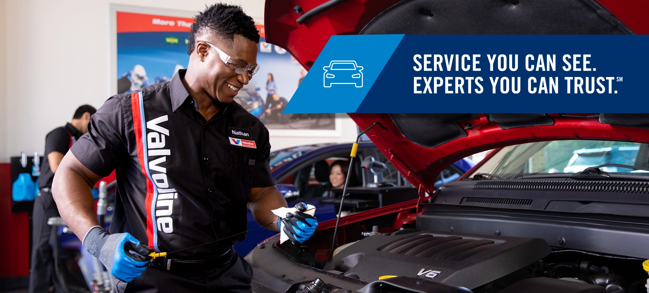 A technician checks oil level during oil change at Valvoline Instant Oil Change. Service you can see, experts you can trust