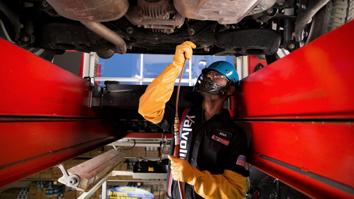 Valvoline technician performing service under car