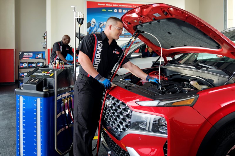 Valvoline Technican replaces transmission fluid in a customer's car.